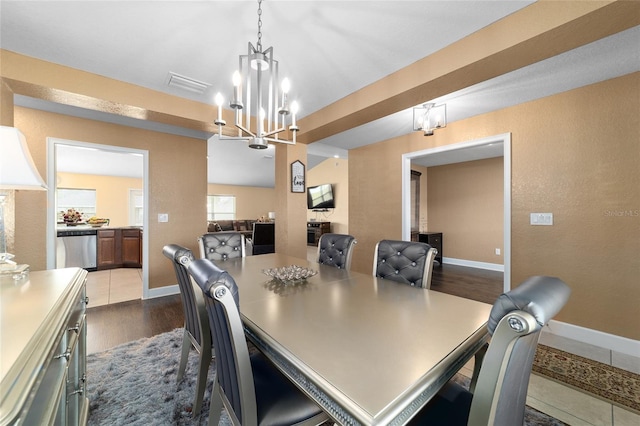 4000 SE 98th Pl, Belleview, FL 34420 - dining room featuring visible vents, a notable chandelier, dark wood finished floors, baseboards, and a textured wall