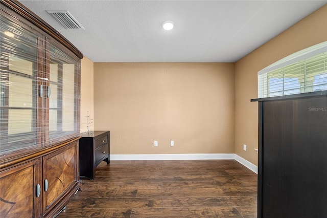 4000 SE 98th Pl, Belleview, FL 34420 - empty room featuring dark wood-type flooring, baseboards, and visible vents