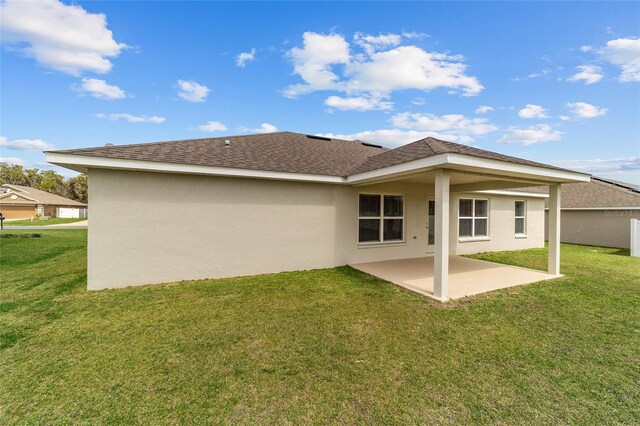 4000 SE 98th Pl, Belleview, FL 34420 - rear view of house featuring a patio area, stucco siding, a shingled roof, and a yard