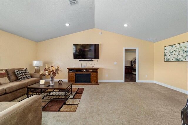 4000 SE 98th Pl, Belleview, FL 34420 - living area with visible vents, baseboards, a fireplace, vaulted ceiling, and carpet flooring