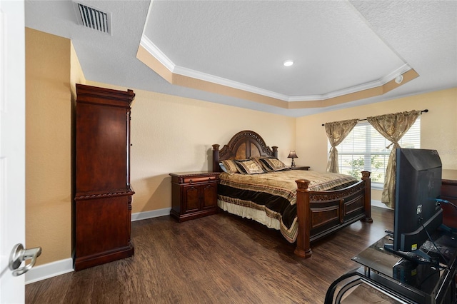 4000 SE 98th Pl, Belleview, FL 34420 - bedroom featuring dark wood-style floors, baseboards, visible vents, ornamental molding, and a raised ceiling