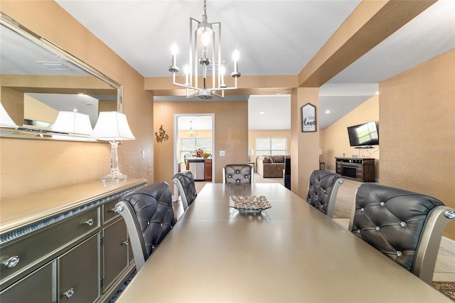 4000 SE 98th Pl, Belleview, FL 34420 - dining room featuring vaulted ceiling, a notable chandelier, and a textured wall