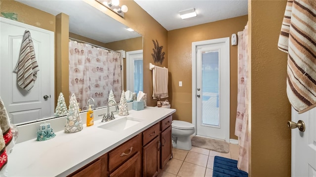 bathroom with vanity, toilet, and tile patterned floors