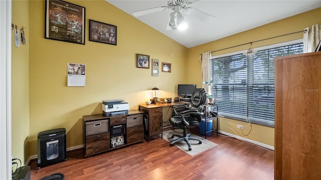 office area with dark wood-style floors, ceiling fan, baseboards, and vaulted ceiling