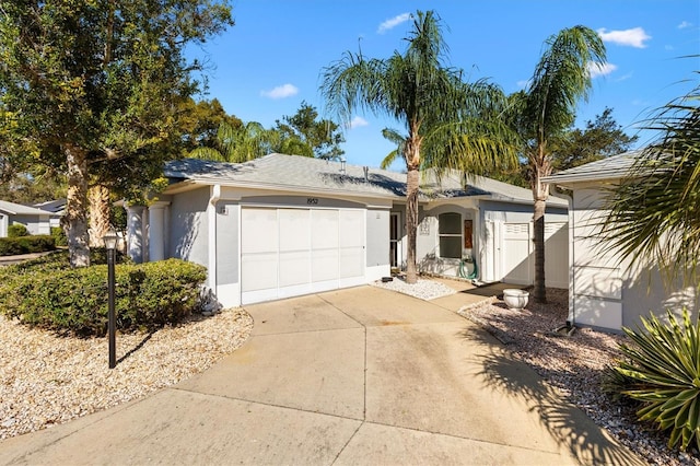 ranch-style house featuring a garage, concrete driveway, and stucco siding