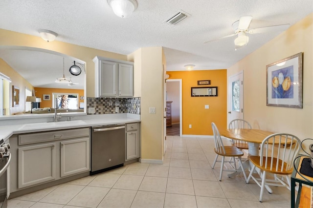 kitchen with visible vents, appliances with stainless steel finishes, gray cabinets, light countertops, and a sink