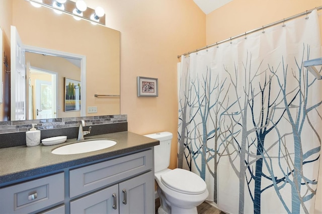 bathroom featuring toilet and vanity