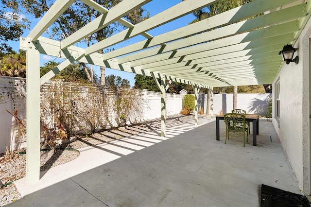 view of patio / terrace with a fenced backyard, a pergola, and outdoor dining space