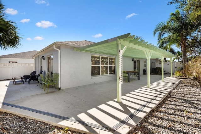 view of side of property featuring a patio, roof with shingles, fence, a pergola, and stucco siding