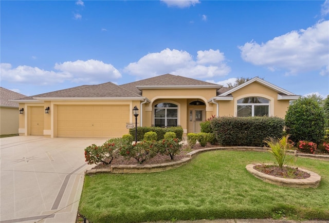 view of front of home with a garage and a front lawn