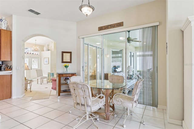 5135 Aurora Dr, Leesburg, FL 34748 - dining area featuring arched walkways, ceiling fan, light tile patterned floors, and visible vents