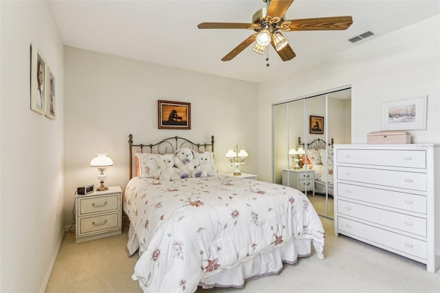 5135 Aurora Dr, Leesburg, FL 34748 - bedroom with a closet, visible vents, a ceiling fan, light carpet, and baseboards