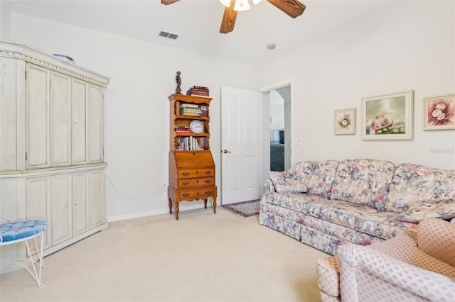 5135 Aurora Dr, Leesburg, FL 34748 - living room with light carpet, baseboards, visible vents, and a ceiling fan