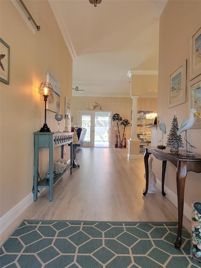 interior space with ornamental molding, ornate columns, and hardwood / wood-style floors