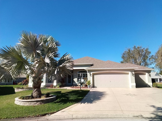 view of front facade featuring a front lawn and a garage