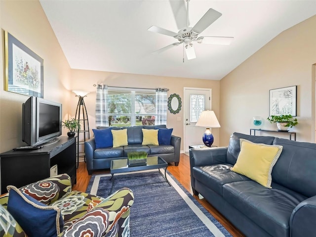 living room with dark wood-style floors, ceiling fan, and vaulted ceiling