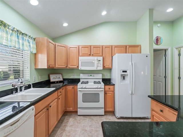 kitchen with white appliances, dark countertops, lofted ceiling, a sink, and recessed lighting