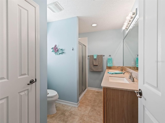 full bath with a sink, double vanity, a shower stall, and toilet