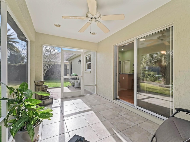 sunroom / solarium featuring ceiling fan