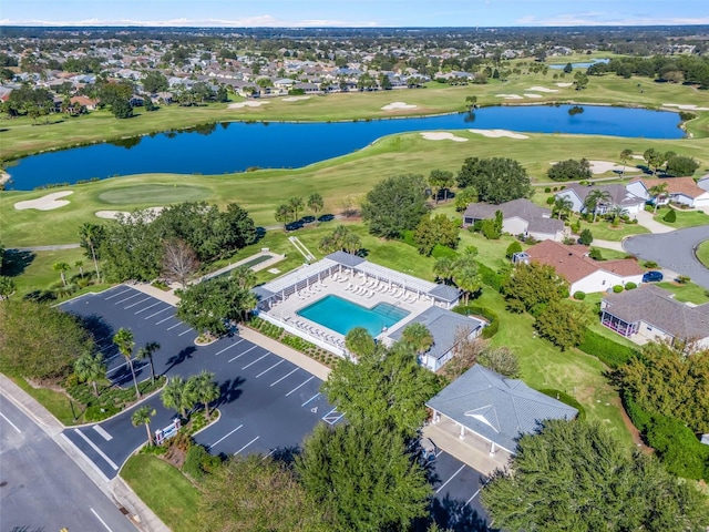 aerial view with a residential view, view of golf course, and a water view