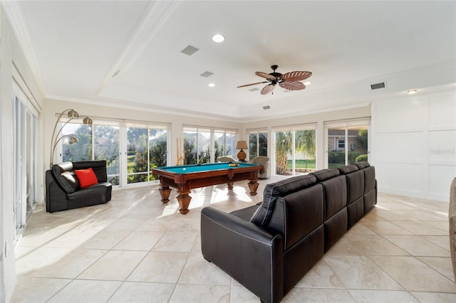 game room featuring a tray ceiling, plenty of natural light, billiards, and ornamental molding