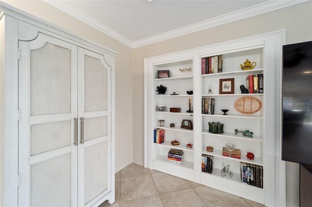 mudroom featuring built in shelves, light tile patterned floors, and crown molding