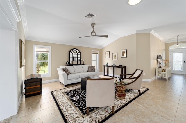 living area with a ceiling fan, visible vents, ornamental molding, and a healthy amount of sunlight