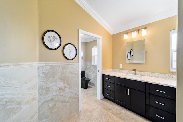 bathroom featuring crown molding, wainscoting, vanity, tile walls, and marble finish floor
