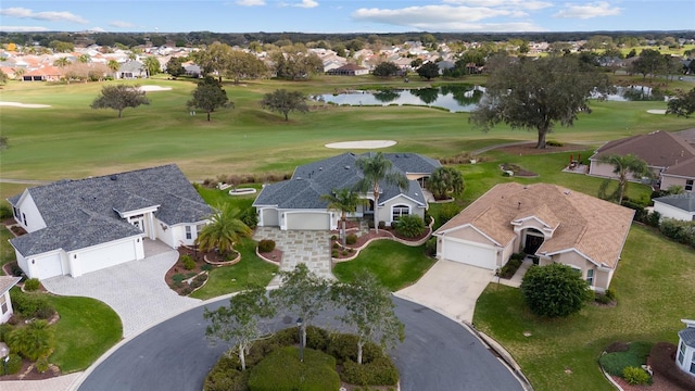 aerial view featuring golf course view, a residential view, and a water view