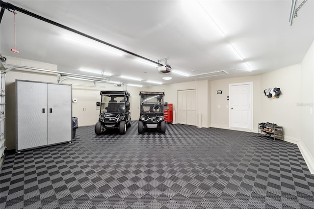 garage with a garage door opener and baseboards