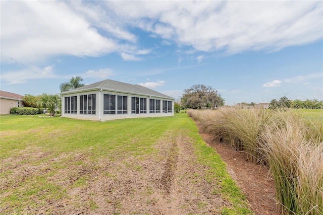 rear view of property featuring a yard