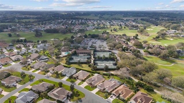 drone / aerial view with a residential view and golf course view