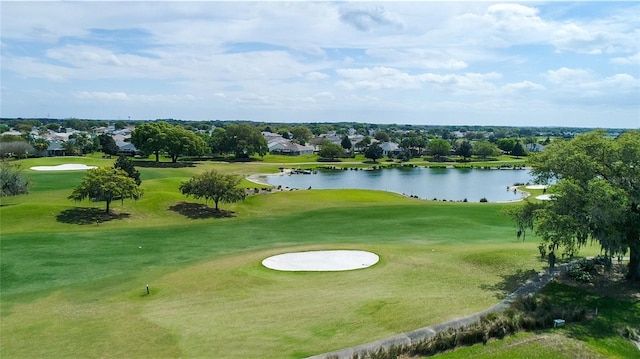 view of home's community featuring a lawn, a water view, and view of golf course