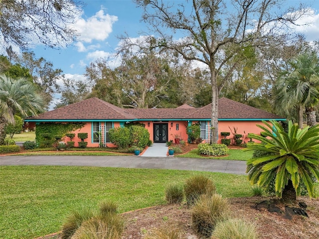 ranch-style house with a front lawn