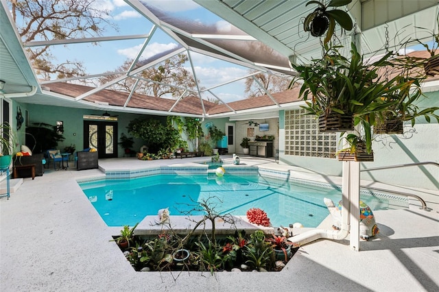 view of swimming pool featuring a patio, french doors, ceiling fan, and a lanai