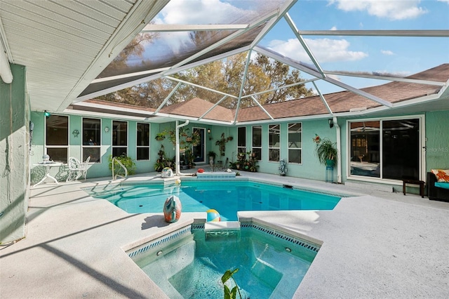 view of pool featuring a patio and glass enclosure