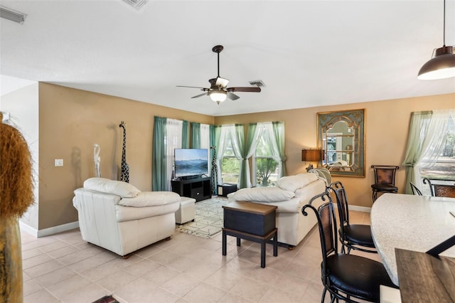 living room with ceiling fan and light tile patterned floors