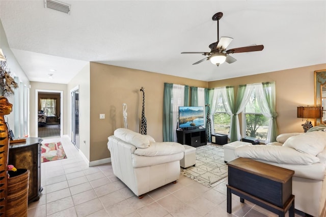 living room featuring light tile patterned floors and ceiling fan