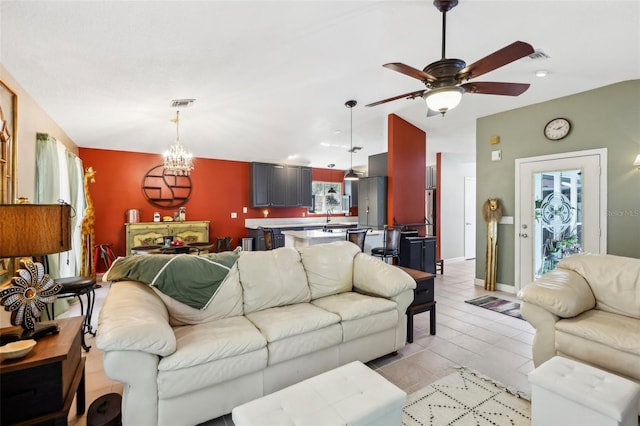 living room with ceiling fan with notable chandelier