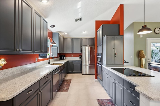 kitchen featuring appliances with stainless steel finishes, light stone countertops, gray cabinetry, and decorative light fixtures