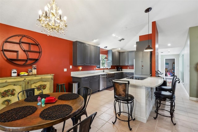 kitchen featuring black electric stovetop, gray cabinets, stainless steel dishwasher, and pendant lighting