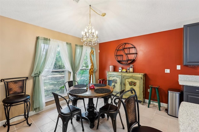 dining area with light tile patterned flooring, a chandelier, and a textured ceiling