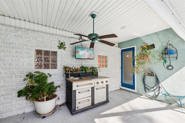 interior space with sink, area for grilling, and ceiling fan