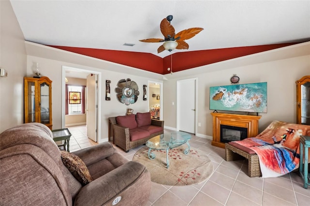 tiled living room featuring lofted ceiling and ceiling fan