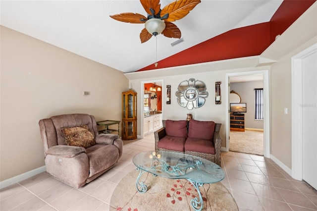 living room featuring vaulted ceiling, ceiling fan, and light tile patterned floors