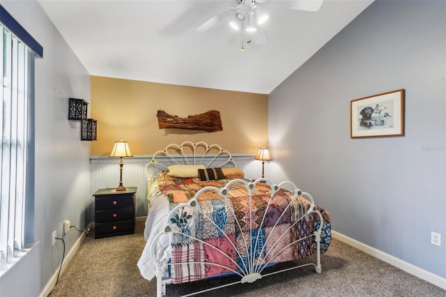 bedroom featuring carpet floors, ceiling fan, vaulted ceiling, and multiple windows