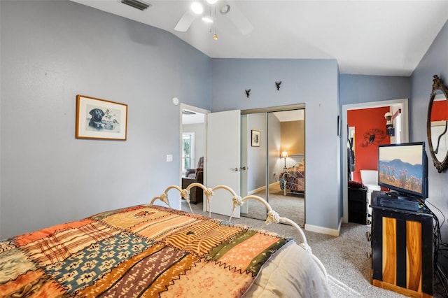 bedroom featuring vaulted ceiling, ceiling fan, a closet, and light colored carpet