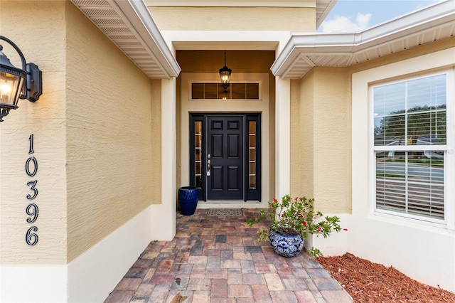 entrance to property with stucco siding