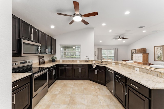 kitchen featuring stainless steel appliances, lofted ceiling, visible vents, a sink, and light stone countertops