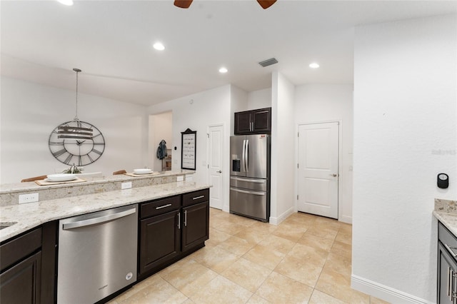 kitchen featuring light stone countertops, visible vents, appliances with stainless steel finishes, and pendant lighting